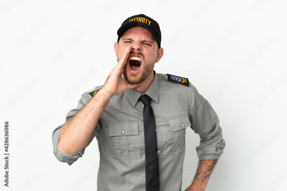 Young security Brazilian man isolated on white background shouting with mouth wide open