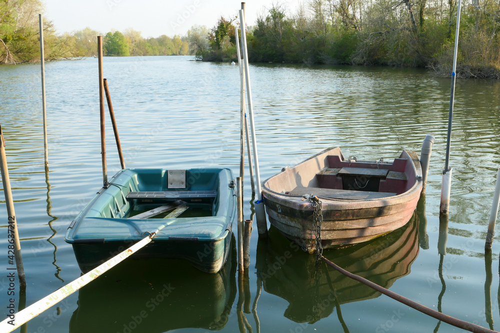 Obraz premium Abandoned rowing boat, isolated on a lake. Two rowboat on water.