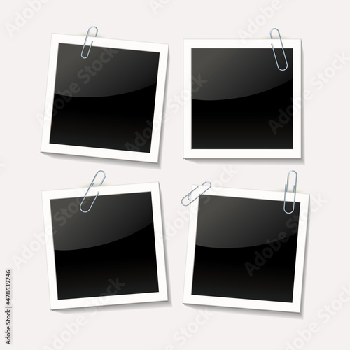 Photos are attached with a paper clip on a white background. Empty photo frame