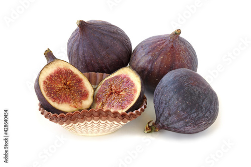 Three figs and slices isolated on white background