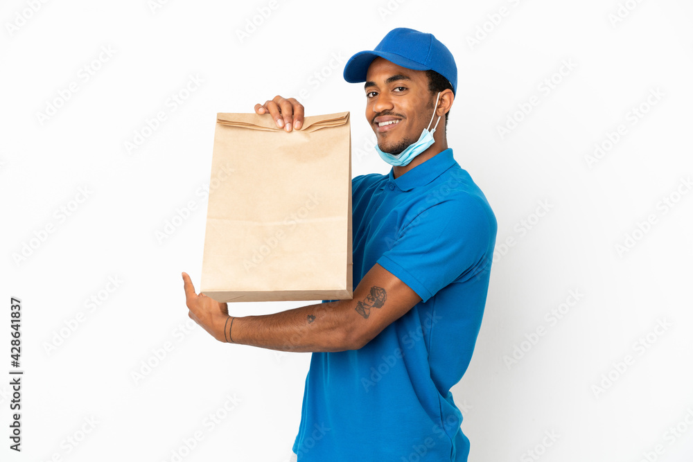 African American man taking a bag of takeaway food isolated on white background pointing back African American man taking a bag of takeaway food isolated on white background pointing back