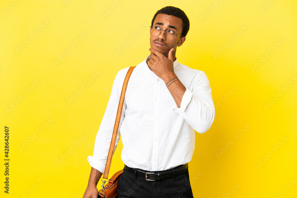 African American business man over isolated yellow background having doubts African American business man over isolated yellow background having doubts
