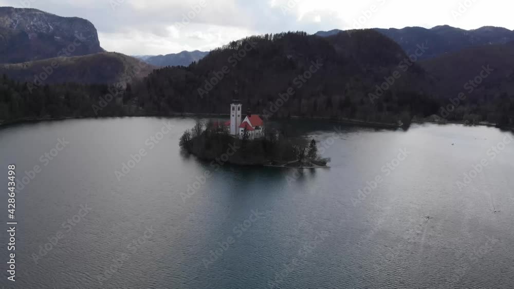Aerial view of Island in Bled Lake. Charming autumn panorama landscape of island with church rounded colorful trees in the middle of Bled lake. Exciting autumn scene of Bled lake at the sunset. Aerial view of Island in Bled Lake. Charming autumn panorama landscape of island with church rounded colorful trees in the middle of Bled lake. Exciting autumn scene of Bled lake at the sunset.