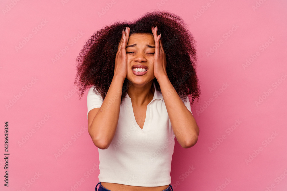 Young african american woman isolated on pink background whining and crying disconsolately. Young african american woman isolated on pink background whining and crying disconsolately.