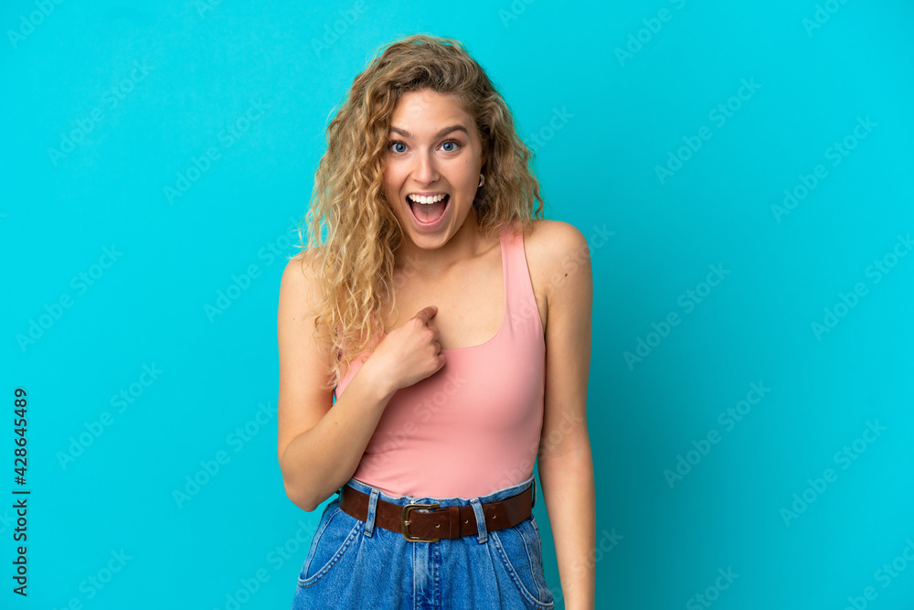 Young blonde woman isolated on blue background with surprise facial expression Young blonde woman isolated on blue background with surprise facial expression
