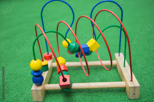 Toy Logic Maze with different figures on a green background