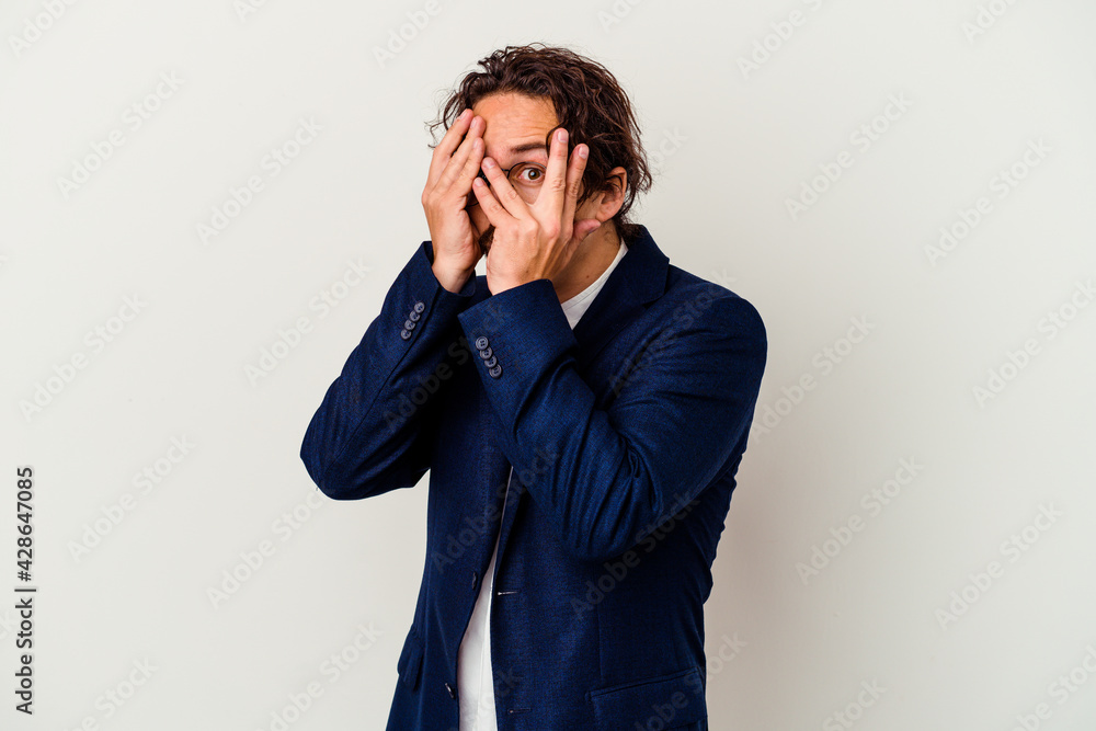 Young business man isolated on white background blink through fingers frightened and nervous. Young business man isolated on white background blink through fingers frightened and nervous.