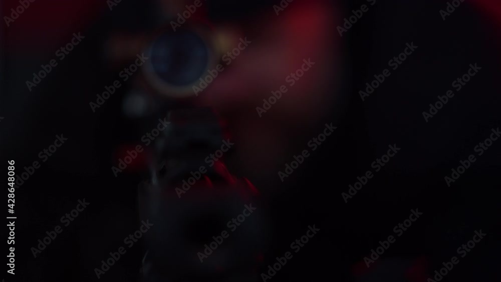 Sniper looking through scope on rifle. Violent man making shot from firearm Sniper looking through scope on rifle. Violent man making shot from firearm