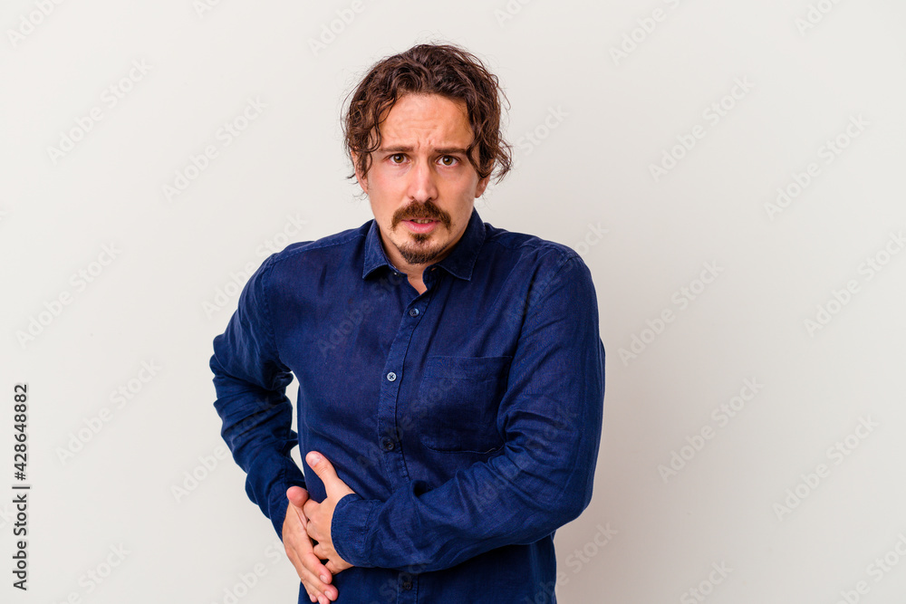 Young caucasian man isolated on white background having a liver pain, stomach ache. Young caucasian man isolated on white background having a liver pain, stomach ache.