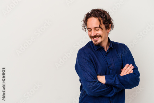 Wallpaper Mural Young caucasian man isolated on white background smiling confident with crossed arms. Torontodigital.ca