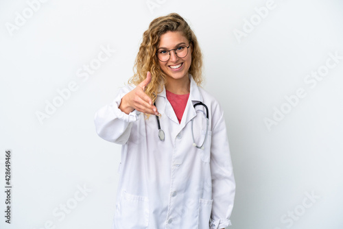 Young doctor blonde woman isolated on white background shaking hands for closing a good deal