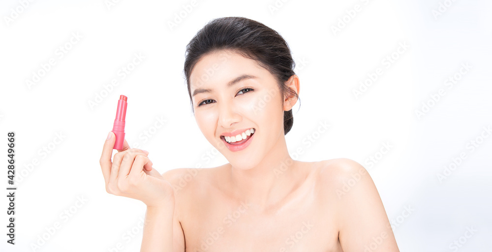 Portrait beauty asian woman fair perfect healthy glow skin.Girl  hand holding apply pink lipstick. Posing a product. Gestures for advertisement. Asia model girl with pretty smile on face isolated.