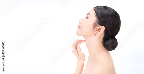 Closeup portrait of beauty asian woman with fair perfect healthy lift glow skin hand touching chin isolated on white, beautiful asia girl with pretty smile on face. Beauty korean spa skincare banner photo