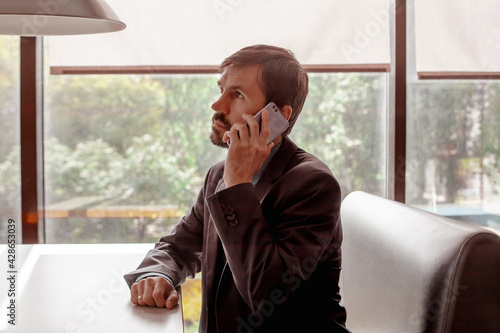 man with phone in cafe