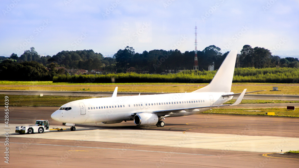 Aircraft being positioned by tug for the flight track. Aircraft being positioned by tug for the flight track.