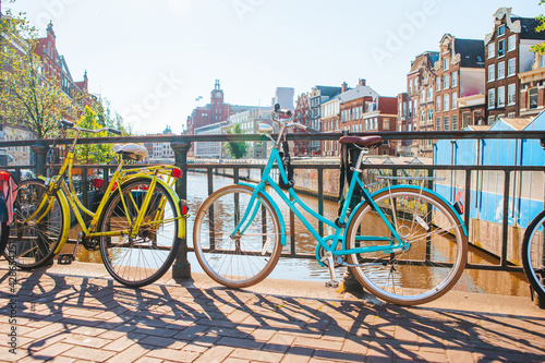 Bikes on the bridge in Amsterdam, Netherlands. Beautiful view of canals in autumn