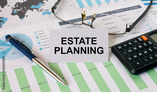 Business Card with text Estate Planning with calculator white pen eyeglasses on the diagrams