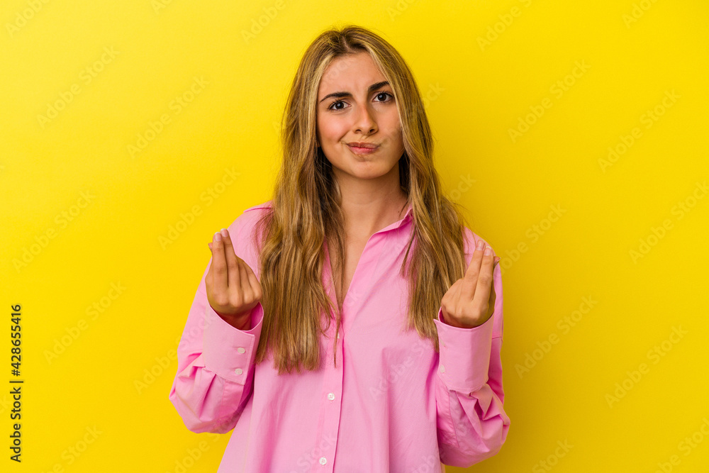Young blonde caucasian woman isolated on yellow background showing that she has no money. Young blonde caucasian woman isolated on yellow background showing that she has no money.