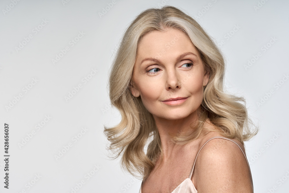 Portrait of adult 50 years old model woman isolated on white background advertising skin care spa treatment. Mid age tightening rejuvenating face and body care cosmetics concept. Portrait of adult 50 years old model woman isolated on white background advertising skin care spa treatment. Mid age tightening rejuvenating face and body care cosmetics concept.