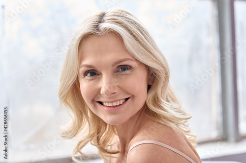 Fotografija Happy mature elder 50s woman indoors