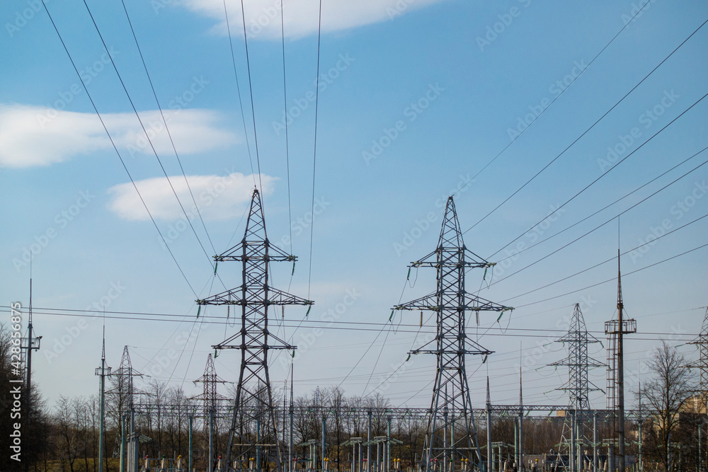 High voltage electric pylon and electrical wire with blue sky background. High voltage grid tower with wire cable at distribution station in the city