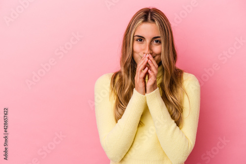 Young blonde caucasian woman isolated on pink background making up plan in mind, setting up an idea.