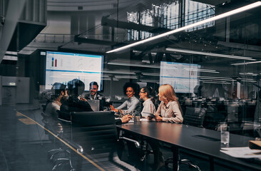 A team of professionals. Group of successful business people working on project presentation in beautiful spacious office. Business, finance concept.