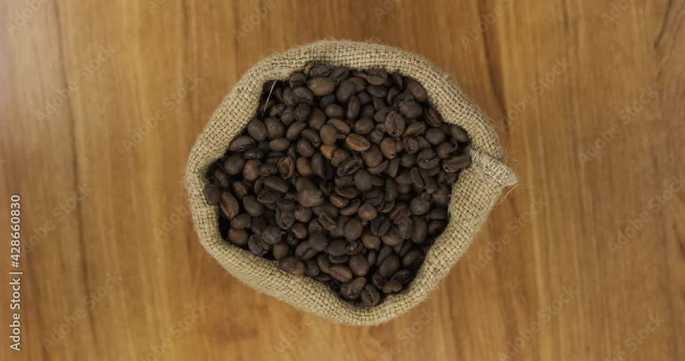 Rotating a full bag of coffee beans. View from above. Rotating a full bag of coffee beans. View from above.