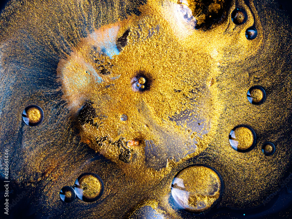 Macro Close Up Shot Of Golden Wet Glitter. Colorful Space Glittering Particle Background. Golden sparkling sand or dust creating abstract cloud formations. Gold industry chemical extraction process.