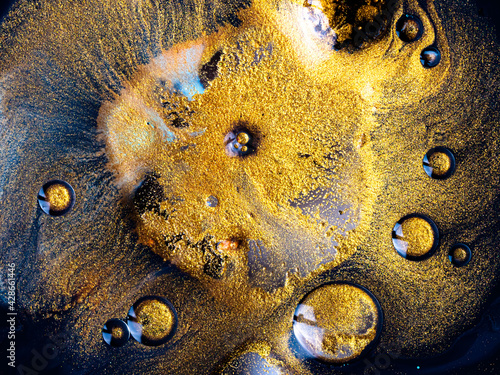 Obraz na płótnie Macro Close Up Shot Of Golden Wet Glitter. Colorful Space Glittering Particle Background. Golden sparkling sand or dust creating abstract cloud formations. Gold industry chemical extraction process. w salonie