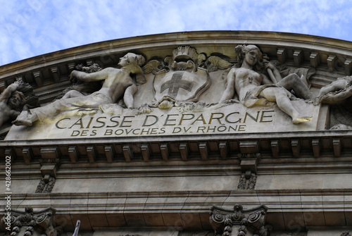Statues of women under the arch. Female sculptures on top of a savings bank building in Marseille, France