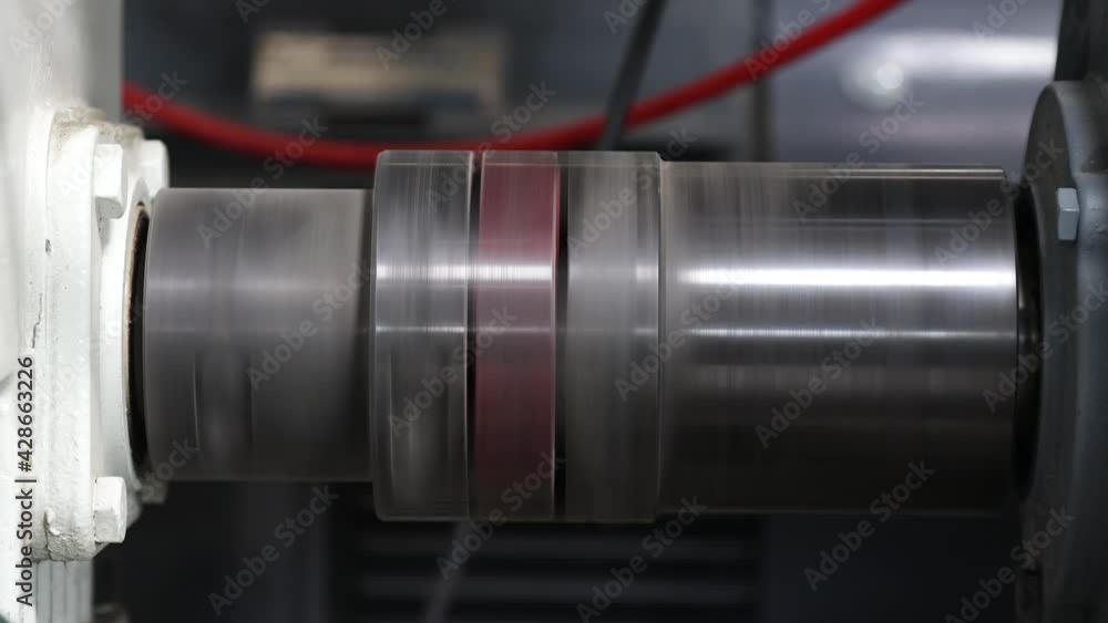 Close-up of a rotating shaft of a processing plant in a factory Close-up of a rotating shaft of a processing plant in a factory