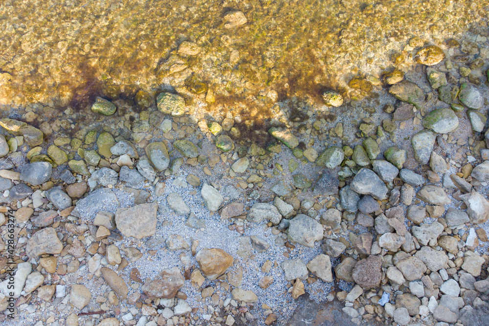Large stones on the seashore, coastline and clear sea water. View from above. Large stones on the seashore, coastline and clear sea water. View from above.