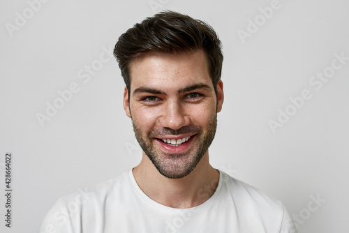Smiling handsome young man in casual white t-shirt