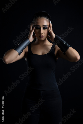 Wallpaper Mural An attractive dark-haired woman in fantasy/urban fantasy style costume  and posing against a plain black backdrop Torontodigital.ca