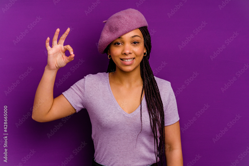 Naklejka premium Young african american woman isolated on yellow background Young african american woman isolated on yellow background cheerful and confident showing ok gesture.