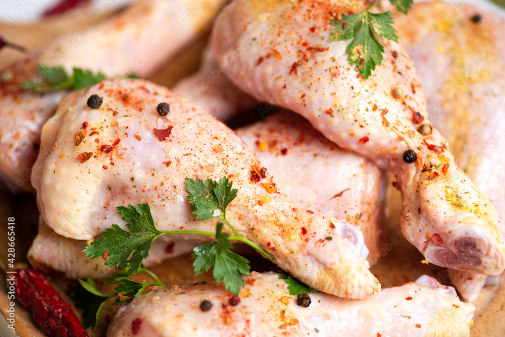 Raw chicken drumsticks with cooking ingredients