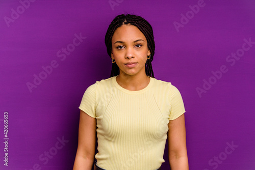 Young african american woman isolated on yellow background Young african american woman isolated on yellow background sad, serious face, feeling miserable and displeased.