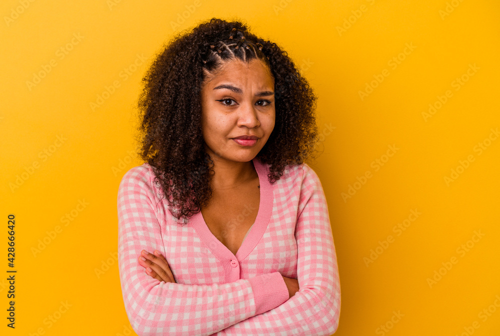 Young african american woman isolated on yellow background unhappy looking in camera with sarcastic expression. Young african american woman isolated on yellow background unhappy looking in camera with sarcastic expression.