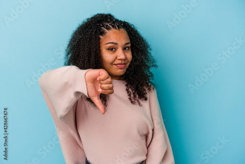 Young african american woman isolated on blue background showing thumb down, disappointment concept.