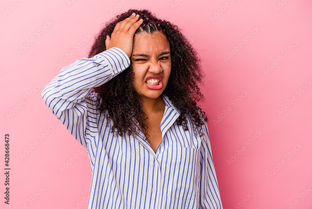 Young african american woman isolated on pink background forgetting something, slapping forehead with palm and closing eyes. Young african american woman isolated on pink background forgetting something, slapping forehead with palm and closing eyes.