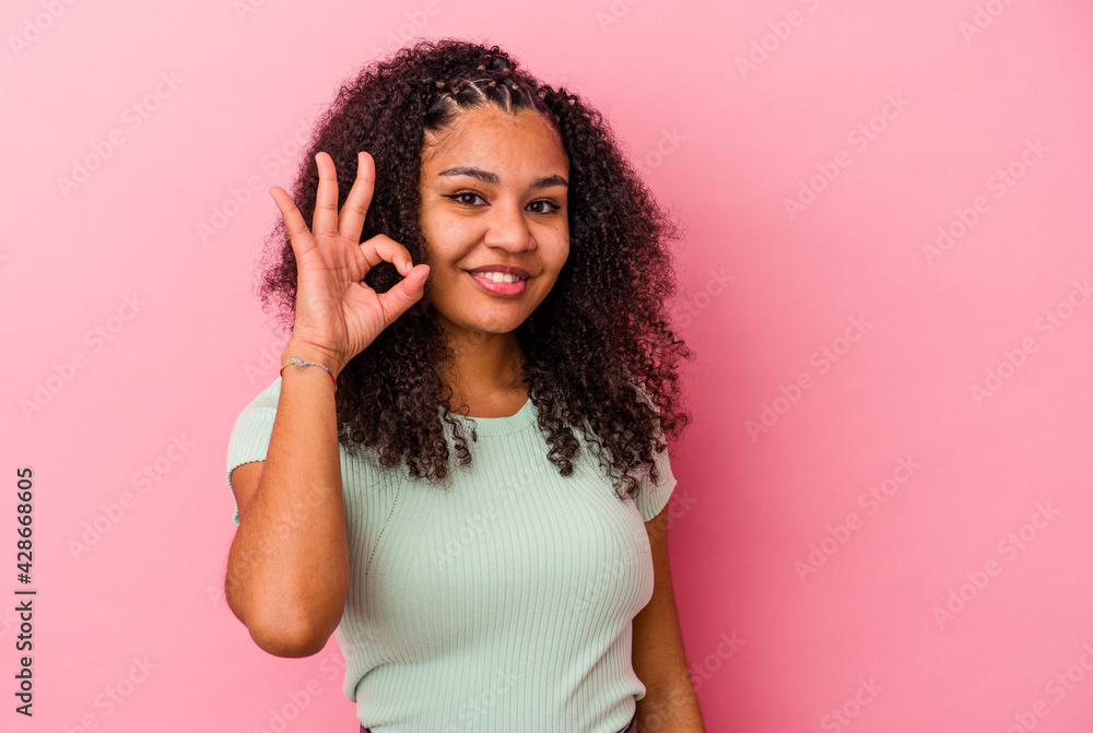 Young african american woman isolated on pink background cheerful and confident showing ok gesture. Young african american woman isolated on pink background cheerful and confident showing ok gesture.