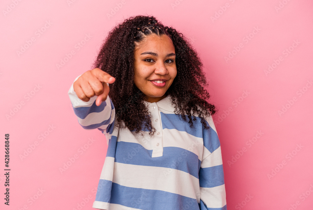 Young african american woman isolated on pink background cheerful smiles pointing to front. Young african american woman isolated on pink background cheerful smiles pointing to front.