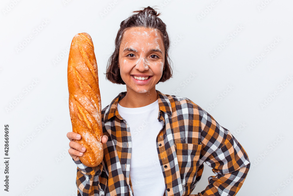 Young mixed race woman making bread isolated on white background happy, smiling and cheerful. Young mixed race woman making bread isolated on white background happy, smiling and cheerful.