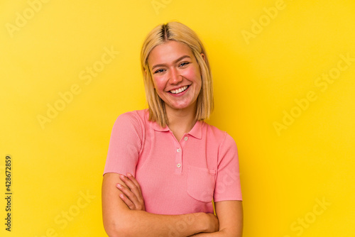 Young venezuelan woman isolated on yellow background laughing and having fun.