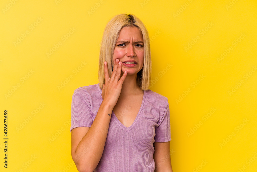 Young venezuelan woman isolated on yellow background having a strong teeth pain, molar ache. Young venezuelan woman isolated on yellow background having a strong teeth pain, molar ache.