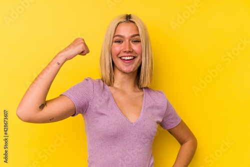 Young venezuelan woman isolated on yellow background cheering carefree and excited. Victory concept.