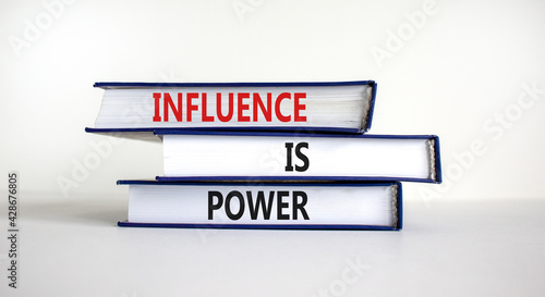 Influence is power symbol. Books with words 'Influence is power'. Beautiful white background. Business, influence is power concept, copy space. photo