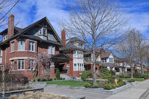 Photography Street with row of large older brick detached houses with gables
