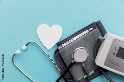 Blood pressure test monitor with a stethoscope on a blue background
